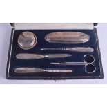 A BOXED SILVER MANICURE SET.