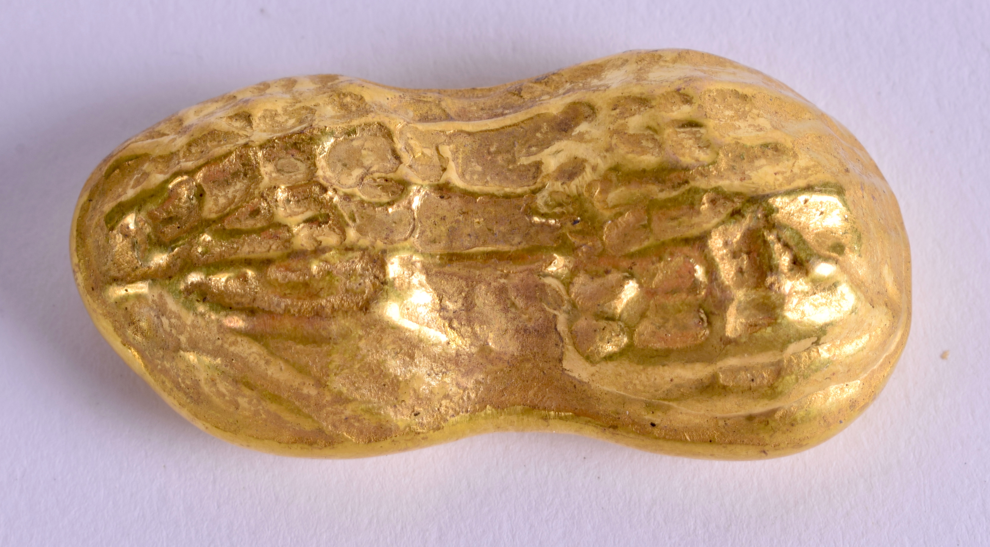 A CHINESE YELLOW METAL INGOT. 79 grams. 4.5 cm x 2 cm.