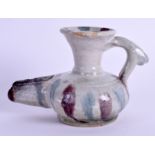 A MIDDLE EASTERN POTTERY JUG. 7 cm wide.