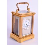 A MINIATURE BRASS CARRIAGE CLOCK. 8 cm high inc handle.