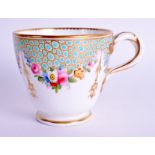 A FINE 19TH CENTURY ENGLISH PORCELAIN COFFEE CUP with entwined handle, painted with flowers. 6.75 c