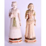 A PAIR OF 18TH CENTURY INDIAN CARVED IVORY FIGURES with polychromed decoration. 19 cm & 18 cm high.