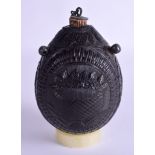 AN EARLY 19TH CENTURY CARVED COCONUT BUGBEAR POWDER FLASK decorated with foliage and flags. 11 cm x