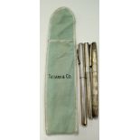 A SOLID SILVER TIFFANY & CO SOLID SILVER PEN, together with two other pens. (3)