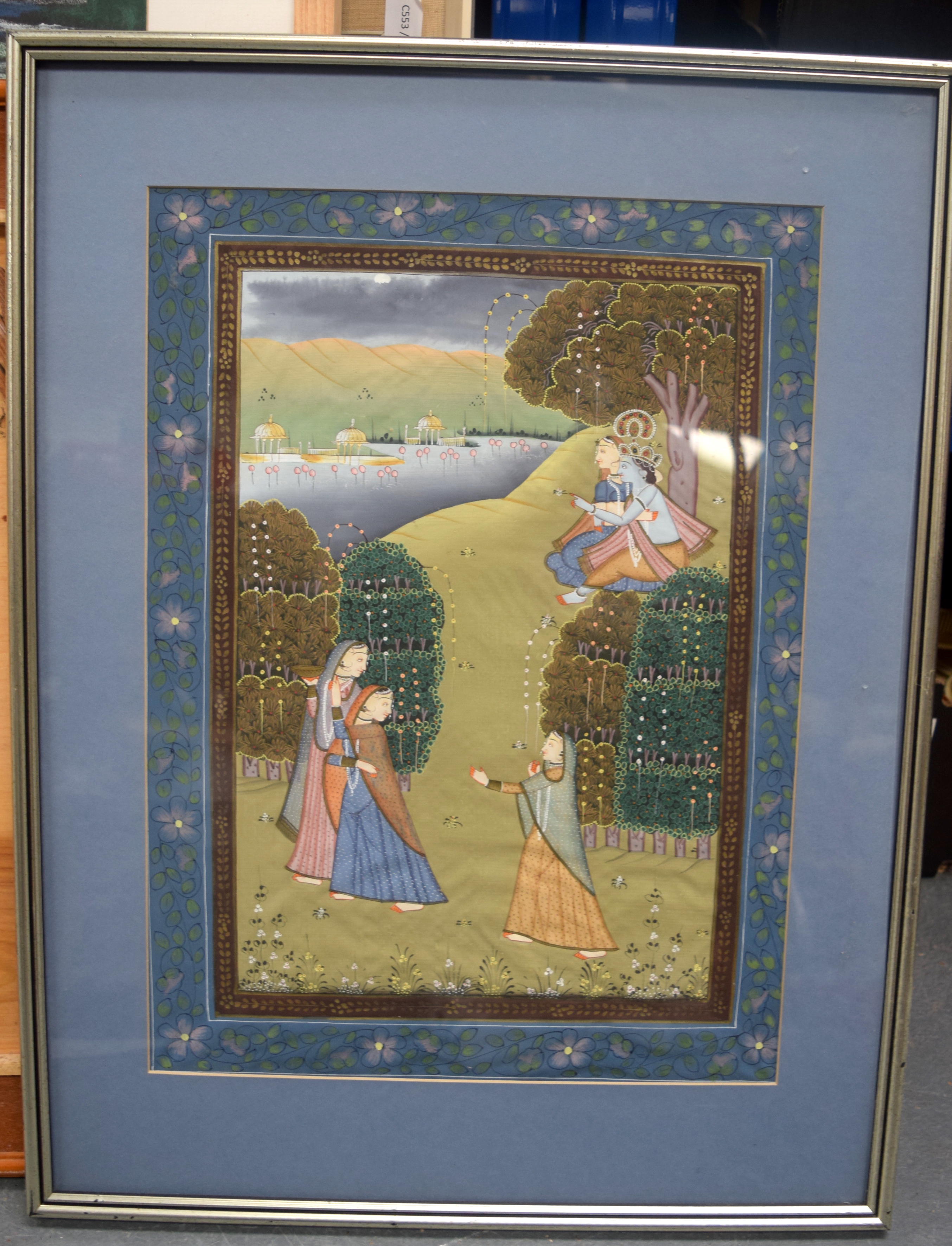 AN EARLY 20TH CENTURY INDIAN GOUACHE ON SILK PAINTING, depicting a God embracing a female in a land