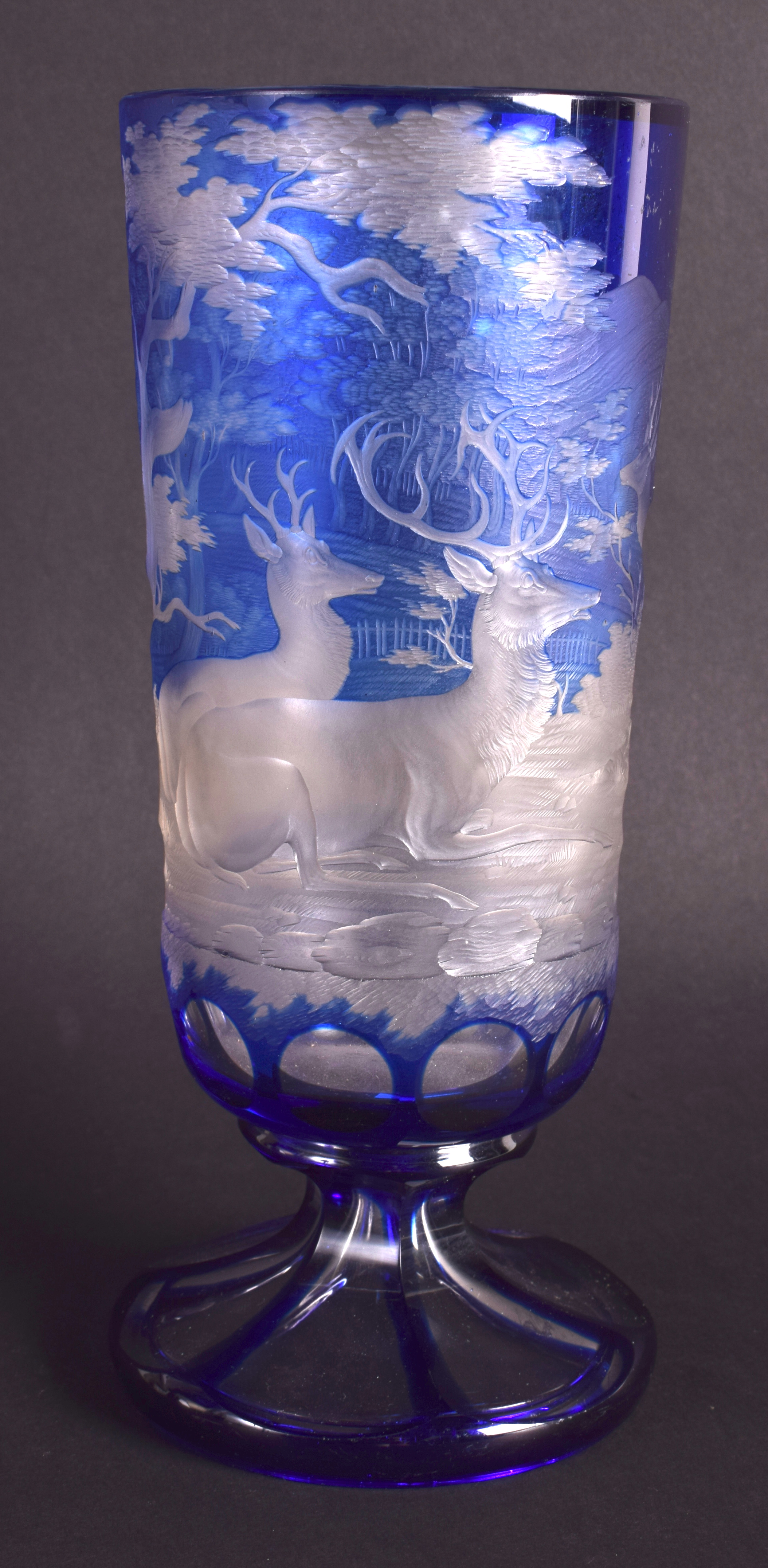 A RARE 19TH CENTURY BOHEMIAN BLUE FLASH GOBLET decorated with stags within landscapes. 21 cm high.