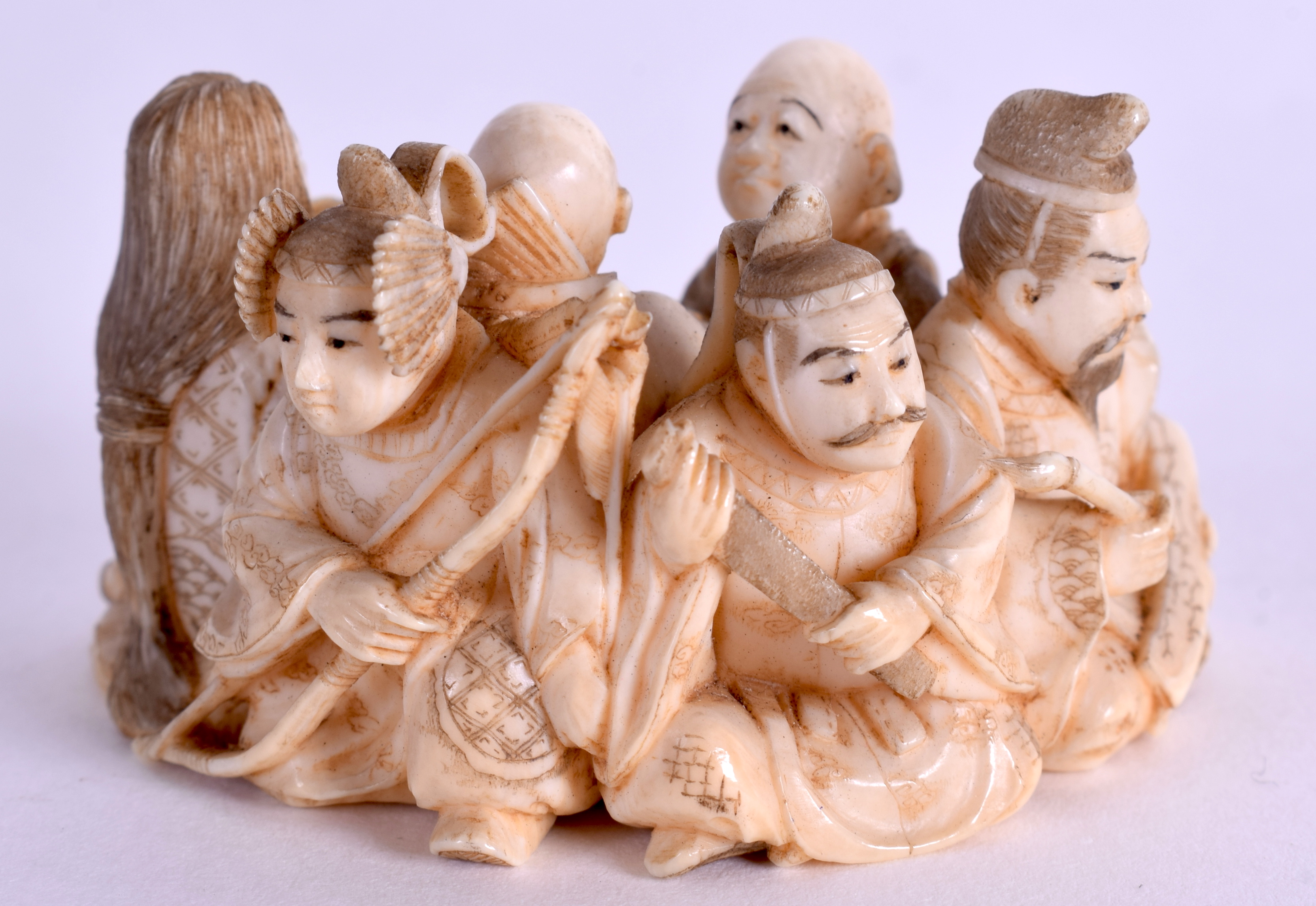 A 19TH CENTURY JAPANESE MEIJI PERIOD CARVED IVORY NETSUKE modelled as numerous figures. 5.5 cm x 3.