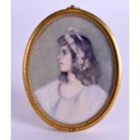 AN EARLY 20TH CENTURY PAINTED IVORY PORTRAIT MINIATURE depicting a girl wearing pink roses within h