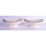 A PAIR OF 18TH/19TH CENTURY WEDGWOOD CREAMWARE RETICULATED BASKETS. 21 cm wide.