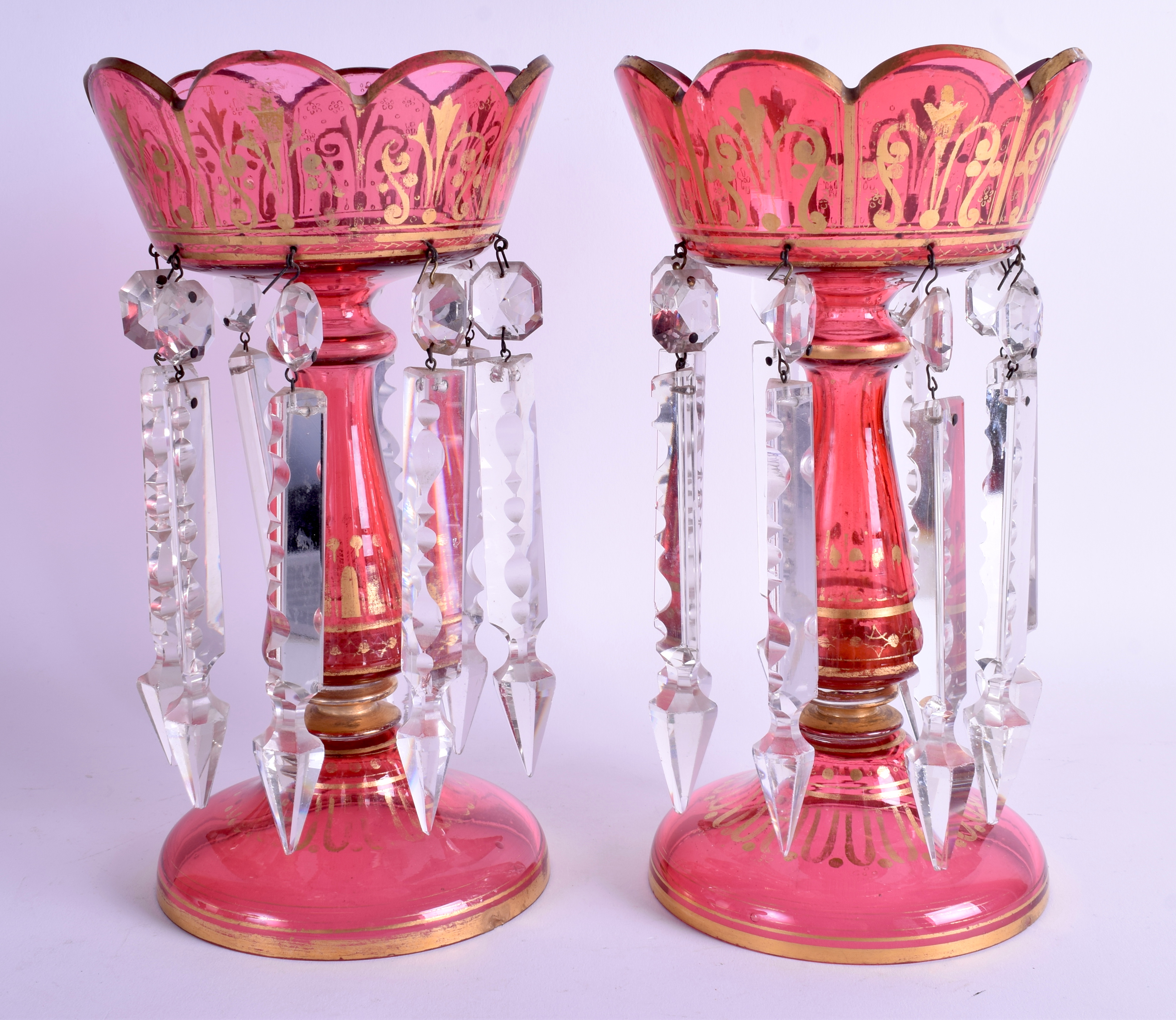 A PAIR OF BOHEMIAN CRANBERRY GLASS LUSTRES with gilt highlights. 26 cm high.