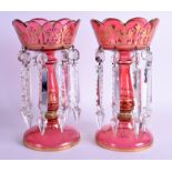 A PAIR OF BOHEMIAN CRANBERRY GLASS LUSTRES with gilt highlights. 26 cm high.