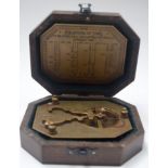 A BOXED SUNDIAL COMPASS, marked “Gilbert & Sons”. 14 cm wide.