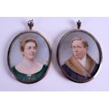 A PAIR OF LATE 19TH CENTURY PAINTED IVORY PORTRAIT MINIATURES within silver frames. 6.5 cm x 7.5 cm