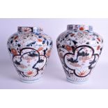 A PAIR OF 18TH CENTURY JAPANESE EDO PERIOD IMARI VASES painted with landscapes. 27 cm high.