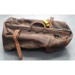 A LARGE ANTIQUE LEATHER BAG, formed with leather strap work. 69 cm wide.