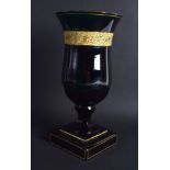 AN EARLY 19TH CENTURY BOHEMIAN GREEN GLASS VASE highlighted with a gilt banding. 24 cm high.