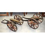 A GOOD LARGE PAIR OF EARLY 19TH CENTURY ENGLISH BRONZE LAWN CANNONS with original wood wheels. 80 c