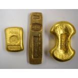 THREE CHINESE YELLOW METAL INGOTS, varying shape. Largest 7.8 cm wide. (3)