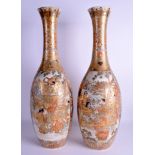 A VERY LARGE PAIR OF 19TH CENTURY JAPANESE MEIJI PERIOD SATSUMA VASES painted with figures. 58 cm h