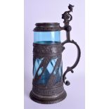 A 19TH CENTURY PEWTER AND BLUE GLASS STEIN decorated with vines and foliage. 33 cm high.