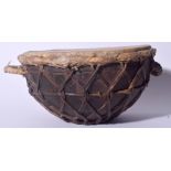 AN ANTIQUE AFRICAN TRIBAL DRUM, formed with twin handles and strap body. 16 cm x 31 cm.