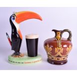 A CARLTON WARE GUINNESS TOUCAN LAMP together with a Dewar's Doulton jug. 25 cm & 17 cm high. (2)