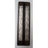 A PAIR OF CHINESE WHITE METAL INSET WOODEN PANELS, decorated with female portraits. 29.5 cm long.