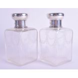 A PAIR OF ANTIQUE SILVER TOPPED CRYSTAL SCENT BOTTLES. London 1916. 16 cm high.