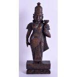 AN 18TH CENTURY INDIAN WOOD FIGURE OF A DEITY modelled holding a flower. 25 cm high.
