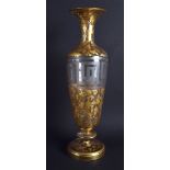 A 19TH CENTURY BOHEMIAN CLEAR AND GILT GLASS VASE painted with flowers. 32 cm high.