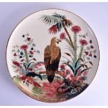 A LARGE HUNGARIAN POTTERY CIRCULAR DISH in the manner of Zsolnay Pecs, painted with a hawk amongst