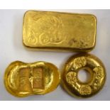 THREE CHINESE YELLOW METAL INGOTS, varying shape. Largest 5.9 cm wide. (3)