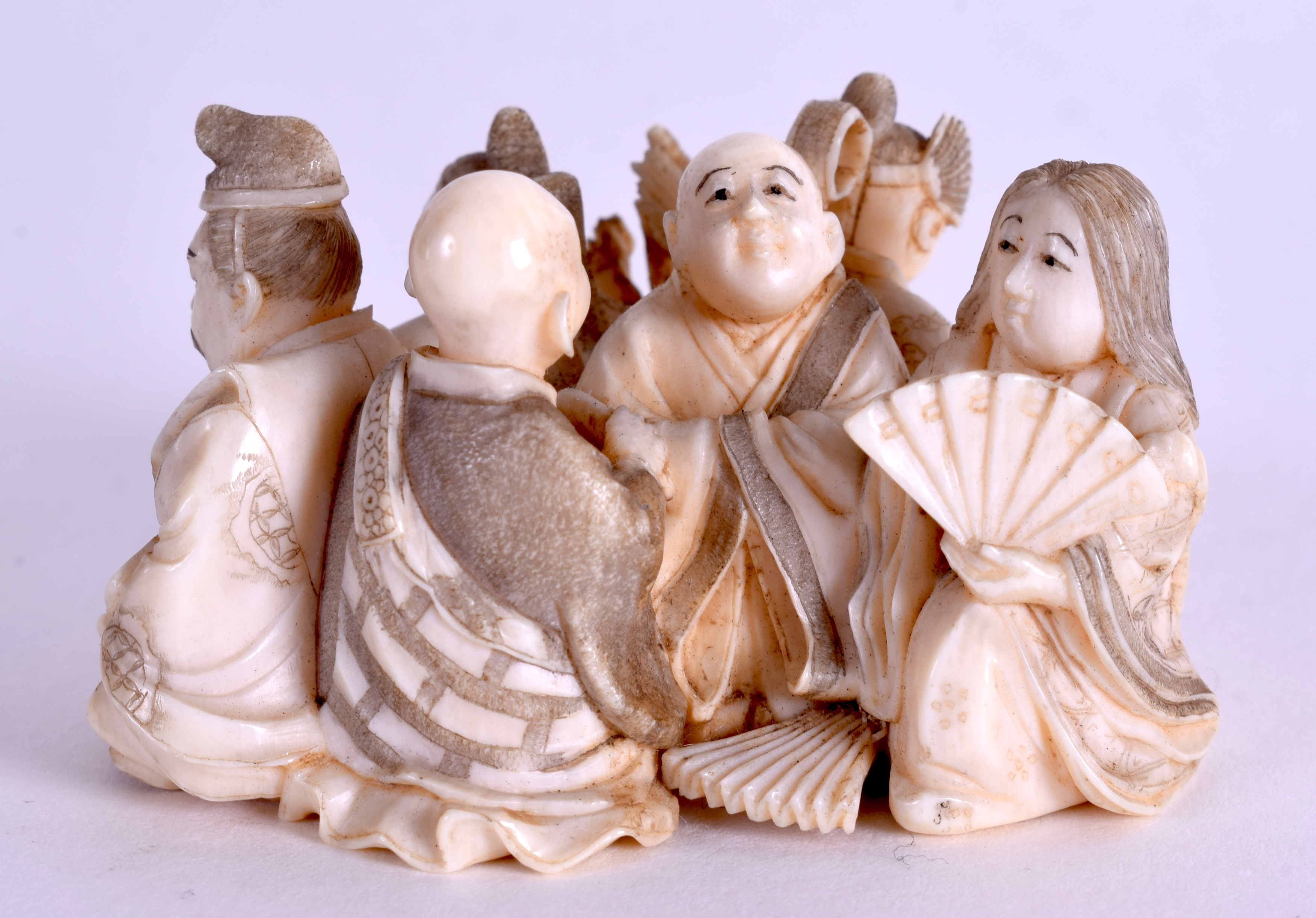 A 19TH CENTURY JAPANESE MEIJI PERIOD CARVED IVORY NETSUKE modelled as numerous figures. 5.5 cm x 3. - Image 2 of 3