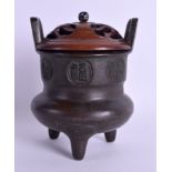 AN 18TH/19TH CENTURY CHINESE TWIN HANDLED BRONZE CENSER decorated with circular calligraphy panels.