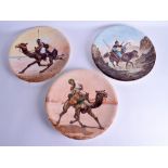 A SET OF THREE 19TH CENTURY CONTINENTAL PORCELAIN CHARGERS painted with a Cossack, Native American