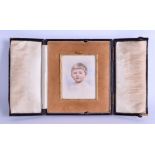 AN EARLY 20TH CENTURY PAINTED IVORY PORTRAIT MINIATURE depicting a young boy with blue eyes. 7.5 cm