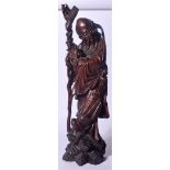 A LARGE EARLY 20TH CENTURY CHINESE CARVED HARDWOOD FIGURE OF AN IMMORTAL, modelled standing holding