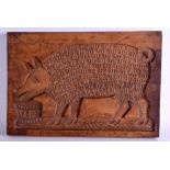 AN EARLY 19TH CENTURY TREEN GINGER BREAD MOULD depicting a pig eating. 46 cm x 30 cm.