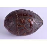 AN EARLY 19TH CENTURY CARVED COCONUT BUGBEAR POWDER FLASK decorated with buildings and berries. 13
