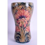 A WILLIAM MOORCROFT MACINTYRE BURSLEM PORCELAIN VASE painted with foliage and vines. 21 cm high.