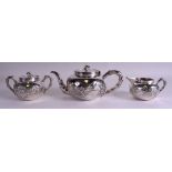 A 19TH CENTURY CHINESE EXPORT THREE PIECE SILVER TEASET by Sing Fat, decorated with foliage. 777 gr