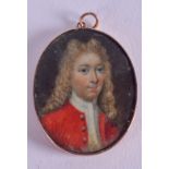 AN EARLY 19TH CENTURY 9CT GOLD IVORY MINIATURE painted as a male wearing red robes. 3 cm x 3.5 cm.