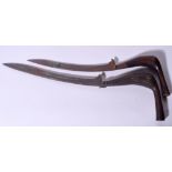 A NEAR PAIR OF INDONESIAN SUMATRA KRIS DAGGER, formed with wooden handles of varying design. 37 cm