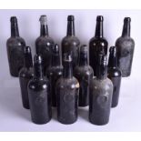 A SET OF TWELVE 18TH CENTURY ENGLISH GLASS WINE BOTTLES set with a central griffin crest over a cyp