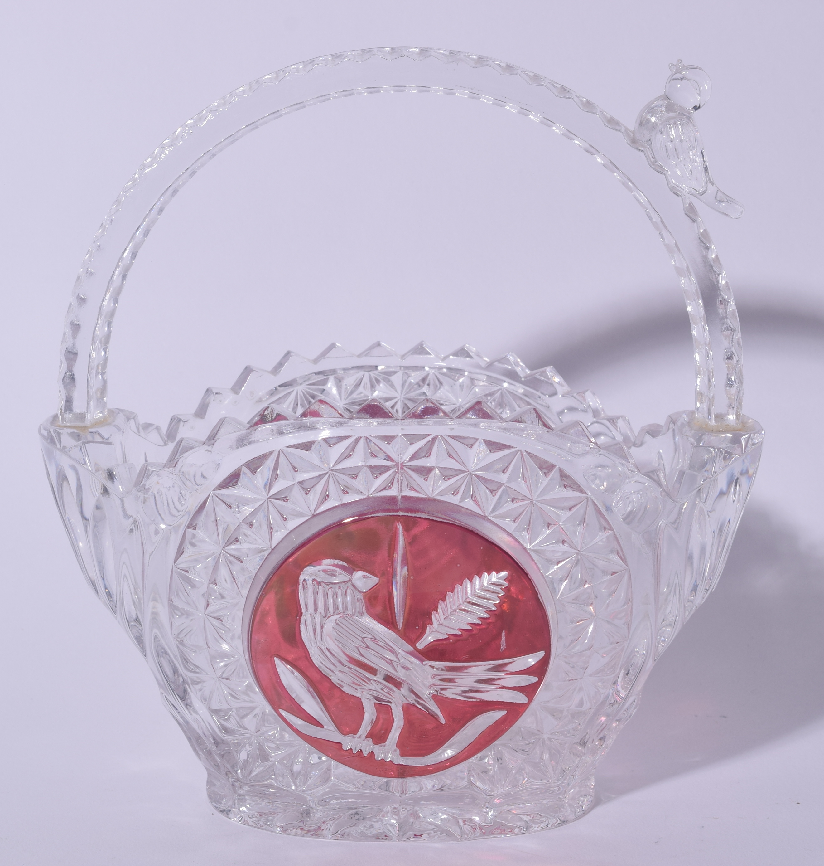 A BOHEMIAN CUT GLASS BIRD BASKET, decorated with central panel depicting a bird on a branch. 18 cm