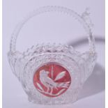 A BOHEMIAN CUT GLASS BIRD BASKET, decorated with central panel depicting a bird on a branch. 18 cm