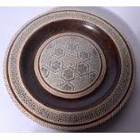 AN EARLY 20TH CENTURY PERSIAN MICRO MOSAIC INLAID DISH, depicting foliage and geometric symbols. 26