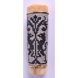 A MID 19TH CENTURY CARVED IVORY BEADWORK PARASOL HANDLE decorated with dragons amongst foliage. 12