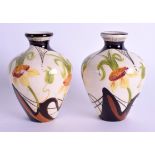 A PAIR OF MOORCROFT BLACK RYDIN PORCELAIN VASES decorated with foliage. 10.5 cm high.