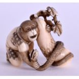 A LOVELY 19TH CENTURY JAPANESE MEIJI PERIOD CARVED IVORY OKIMONO modelled as a monkey grappling wit